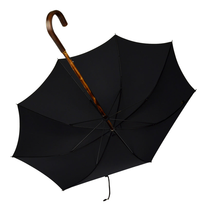 Olive-green umbrella with rust-red dots and handle made of chestnut wood